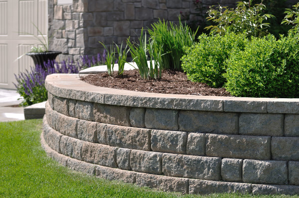 Curved grey stone landscape retaining wall