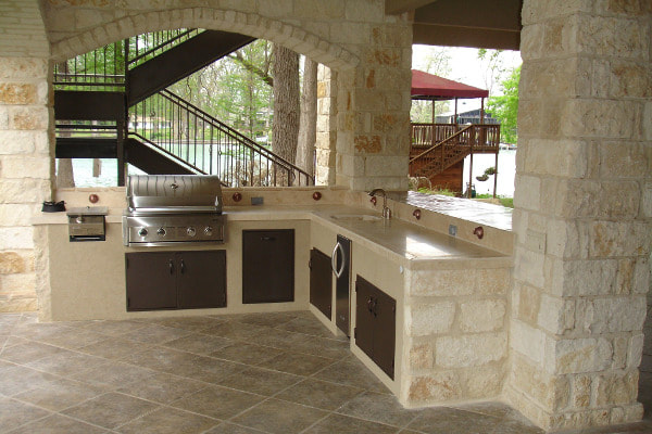 Beige stone outdoor kitchen and barbeque