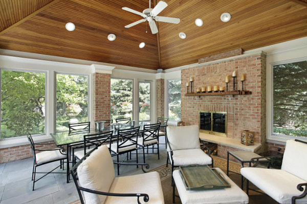 Sunroom patio room with brick fireplace and accent pillars