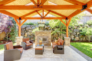 Covered patio with stacked stone fireplace and concrete patio