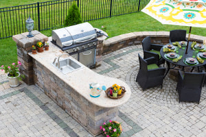 Outdoor stone kitchen island barbeque on patio