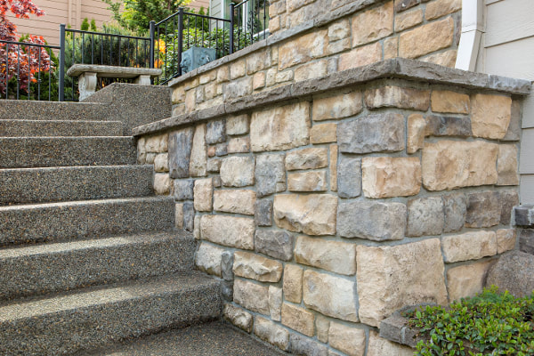 Exterior concrete steps with small stone surround wall